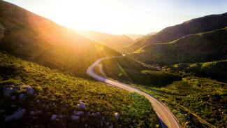 mountain pass during sunrise by Matt Howard courtesy of Unsplash.