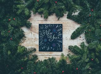 green Christmas decor with New Year greetings by Annie Spratt courtesy of Unsplash.