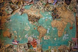 U.S. dollar banknote with map by Christine Roy courtesy of Unsplash.